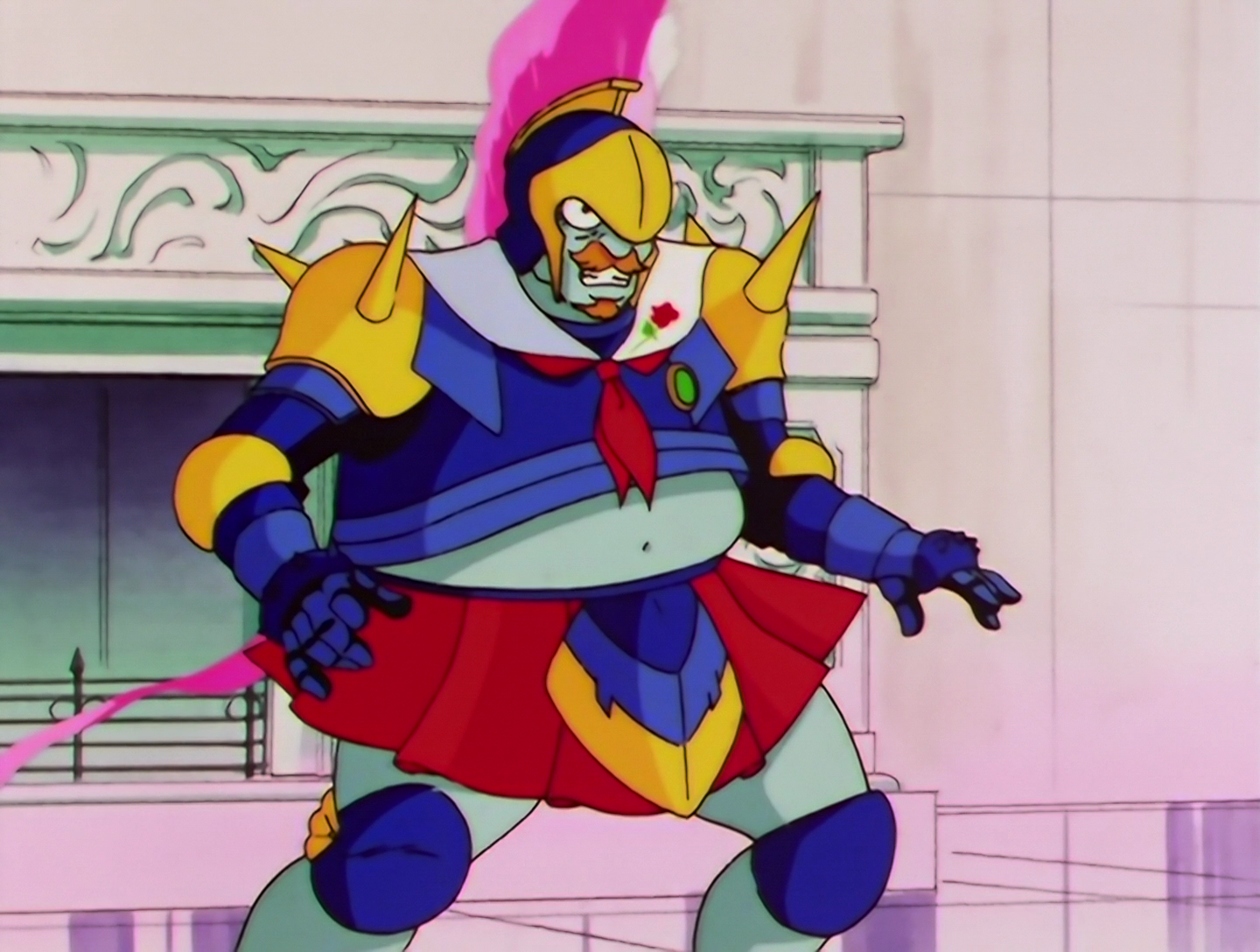 Sailor Antique, a Phage from Sailor Moon episode 186. He’s a burly guy with light turquoise skin and a ginger mustache and beard. He’s wearing blue and gold spiked armor, with a white sailor collar that has a flower motif. He also has a red skirt, and his outfit doesn’t quite fit, so his belly is partly exposed. He also has a blue and gold Roman style helmet with a long pink crest that trails down behind him.